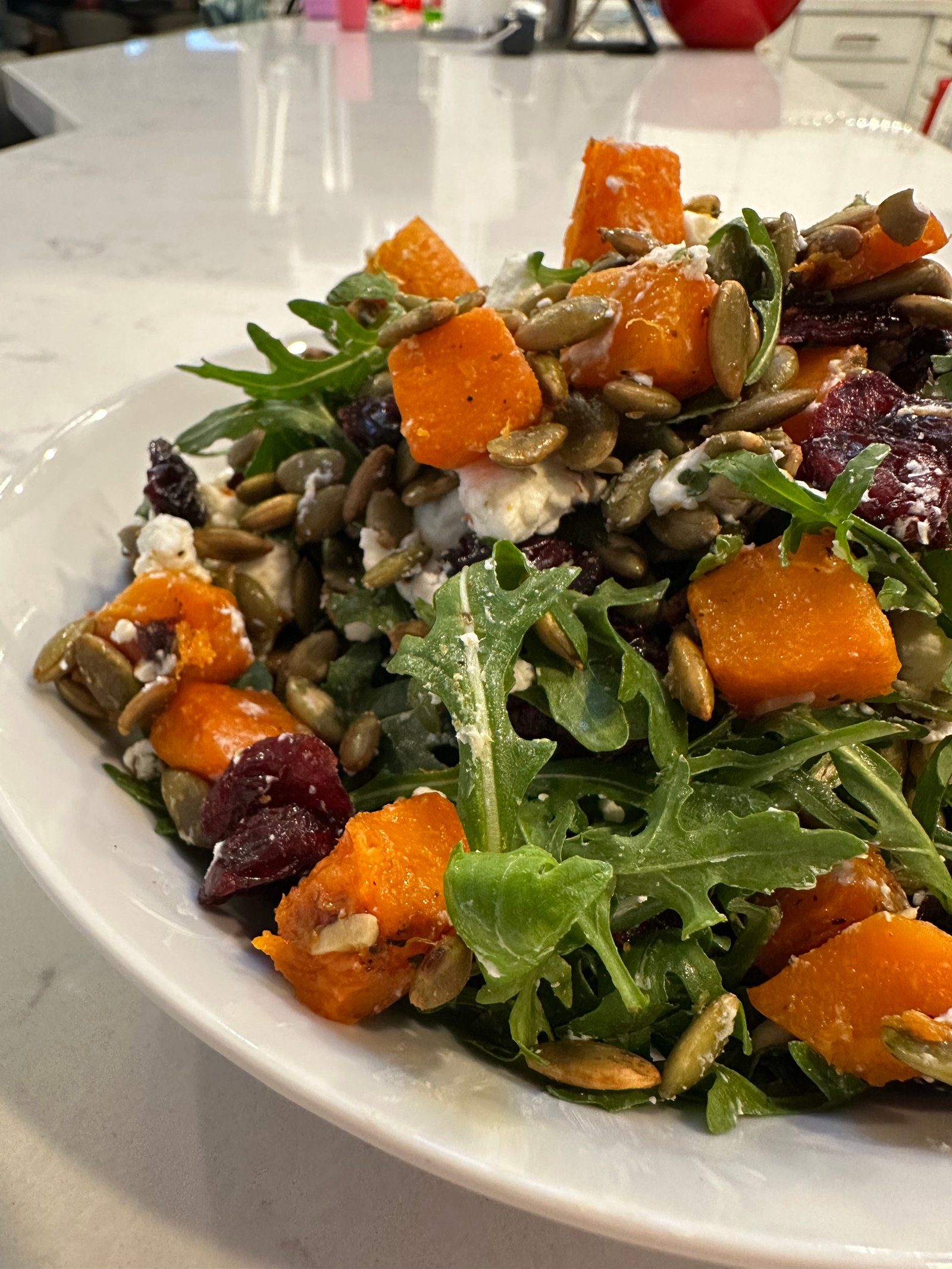 Roasted butternut squash salad with arugula, goat cheese, pumpkin seeds and dried cranberries