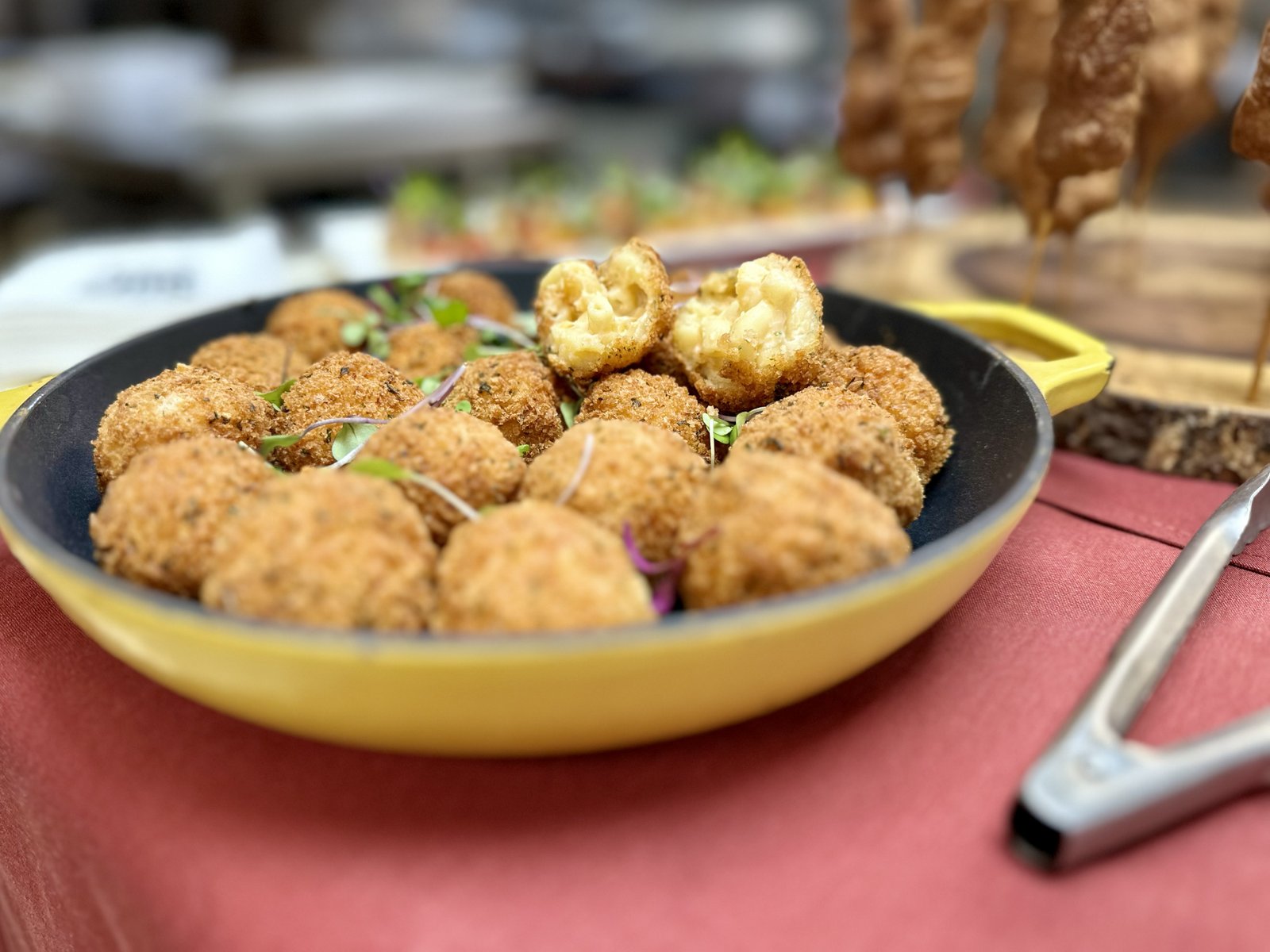 Golden fried mac and cheese balls with one split open